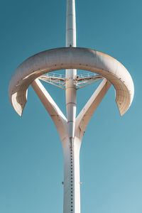 Low angle view of crane against clear blue sky