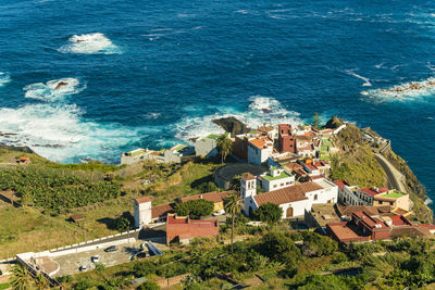 Farm village by the coast of tenerife with turquoise blue sea water