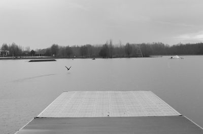 Scenic view of lake against sky during winter