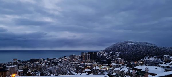 Panoramic view of buildings and sea against sky