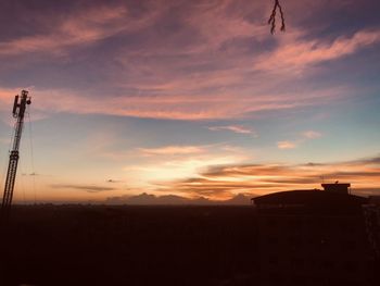 Low angle view of silhouette building against sky during sunset