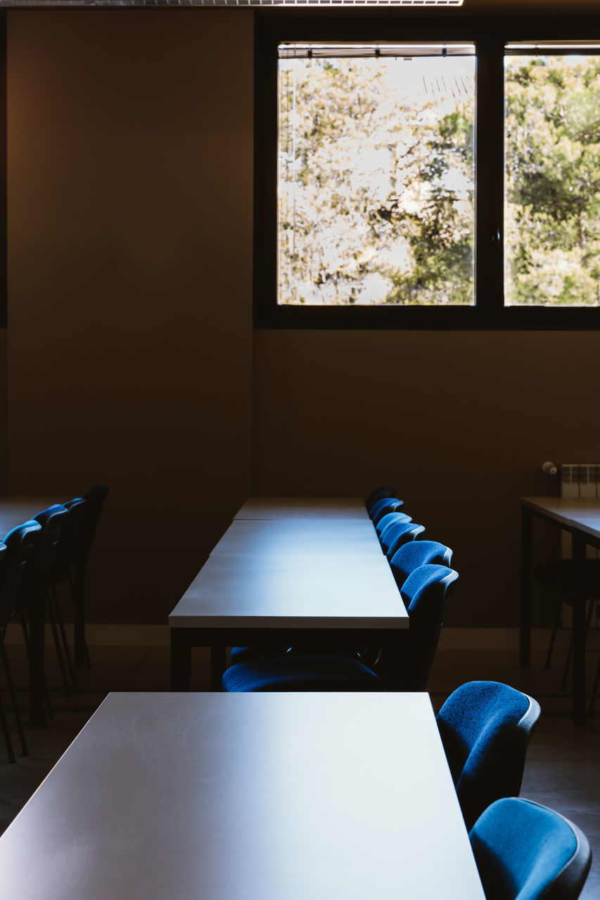 EMPTY CHAIRS AND TABLES IN RESTAURANT