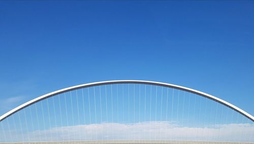 Low angle view of bridge against blue sky