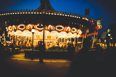 Illuminated ferris wheel at night