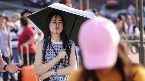 Full length of friends standing against blurred background