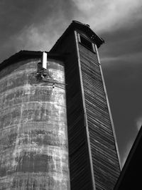 Low angle view of modern building against cloudy sky