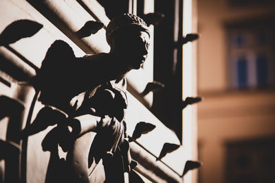 Side view of woman sitting at home