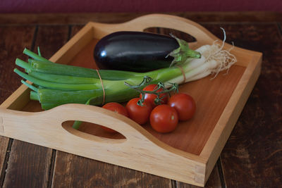 Close-up of tomatoes and vegetables on cutting board