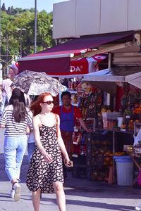 Women standing at market in city