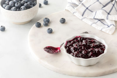 Close up above view of a small bowl of freshly made blueberry sauce.