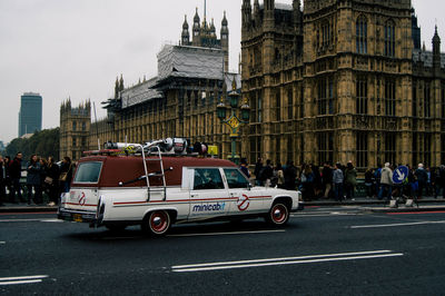 Vehicles on road amidst buildings in city