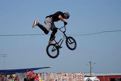 Man riding bicycle against clear sky