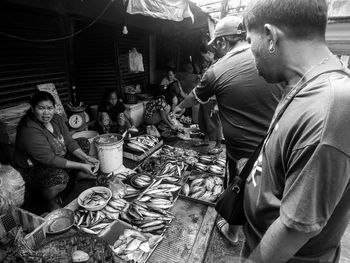 Rear view of people sitting at market