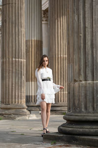 Full length of a woman standing against building