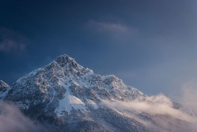 View of snowcapped mountain against cloudy sky