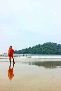 Man on beach against sky