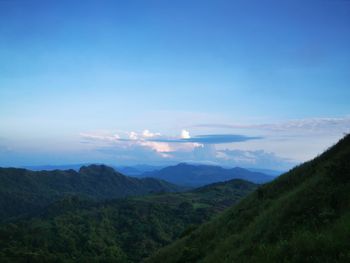 Scenic view of mountains against blue sky