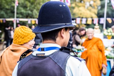 Rear view of people standing outdoors