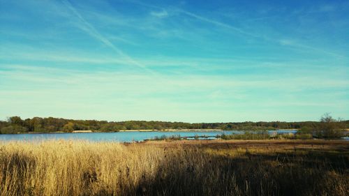 Scenic view of lake against cloudy sky