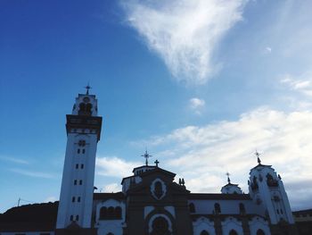 Low angle view of bell tower against cloudy sky