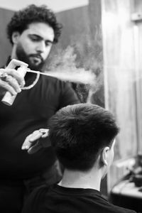 Portrait of young man holding camera