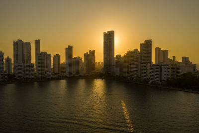 Miami bayfront skyline at night with actual reflections in water aerial view