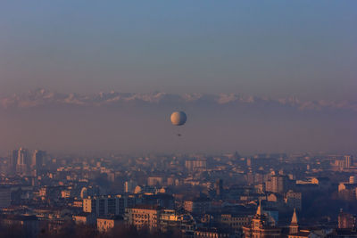 View of cityscape against sky at sunset