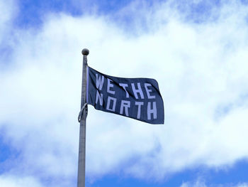 Low angle view of road sign against sky