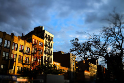 Low angle view of buildings against cloudy sky