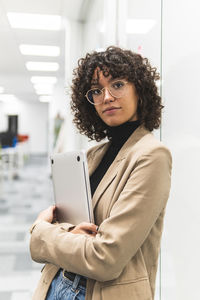 Portrait of young woman using mobile phone