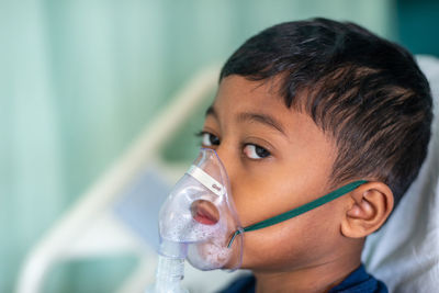 Close-up portrait of boy drinking water from glass