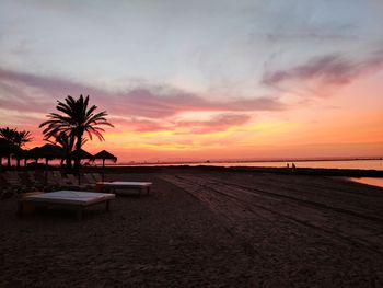 Scenic view of beach against sky during sunset