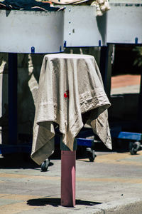 View of textile drying on footpath pole