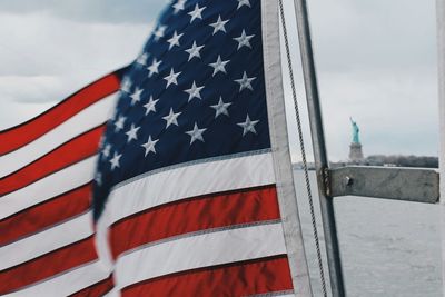 American flag against statue of liberty