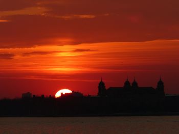 Silhouette of landscape against dramatic sky during sunset