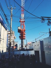 Low angle view of electricity pylon against sky