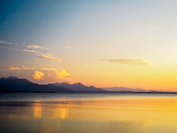 Scenic view of lake at sunset