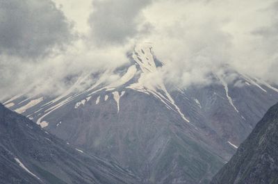 Aerial view of snowcapped mountains against sky
