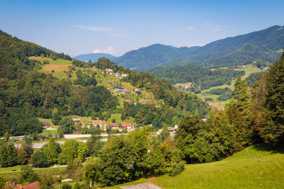 Scenic view of townscape and mountains against sky