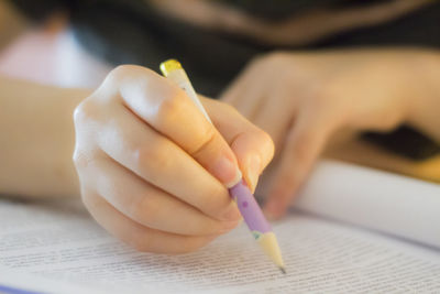 Close-up of woman hand holding book