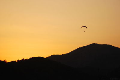 Scenic view of silhouette mountains against sky during sunset