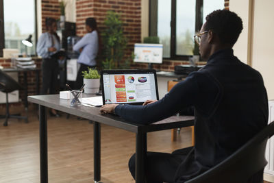 Rear view of businessman working in office