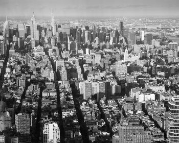 Aerial view of buildings in city against sky