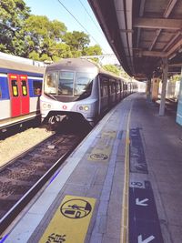 Train at railroad station platform against sky