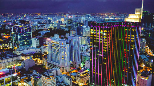 High angle view of illuminated modern buildings in city against sky