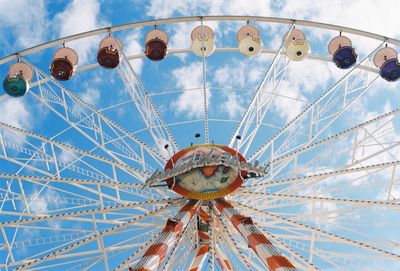 Ferris wheel against cloudy sky