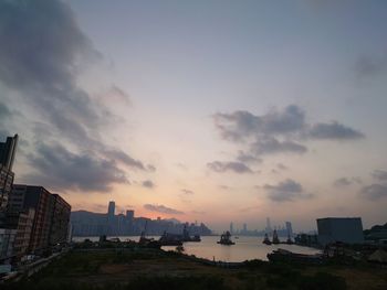 View of buildings against cloudy sky during sunset