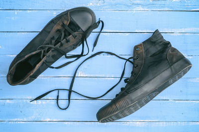 Close-up of shoes on blue table