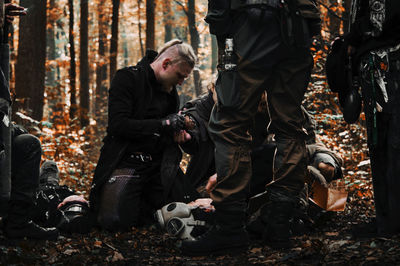 Friends standing on street in forest