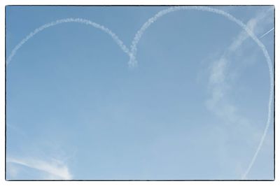 Aerial view of vapor trail against blue sky